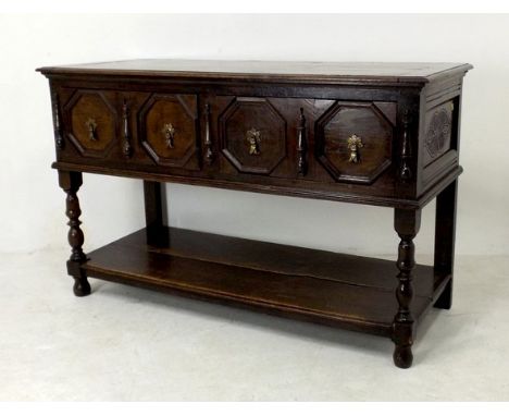 A 17th century oak dresser, the planked top with cleated ends, the geometric moulded drawers with cast brass drop handles on 