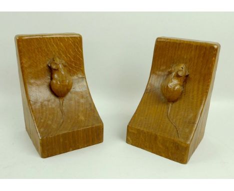 A pair of oak Robert 'Mouseman' Thompson book ends, circa 1970, wedge shaped with carved mouse signature, 10 by 9.5 by 16cm h