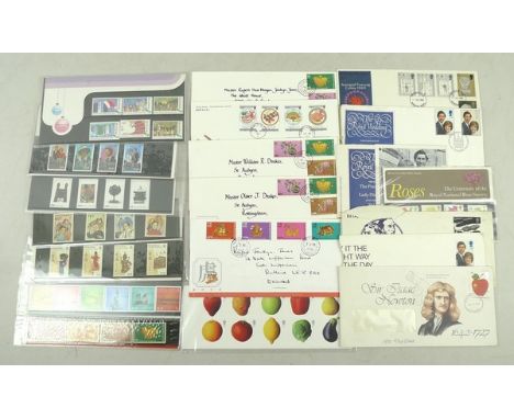 A collection of First Day Covers, mint stamps and uncirculated English bank notes.