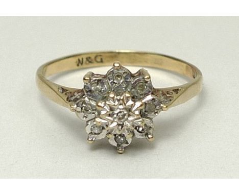 A gold and diamond flower head ring, of eight petals, size R, marks rubbed, 2g. 