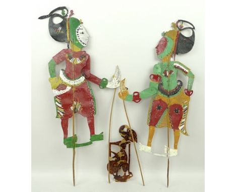 An Indonesian tortoiseshell shadow puppet, 17cm high, and two hand painted shadow puppets, 28cm high. (3)