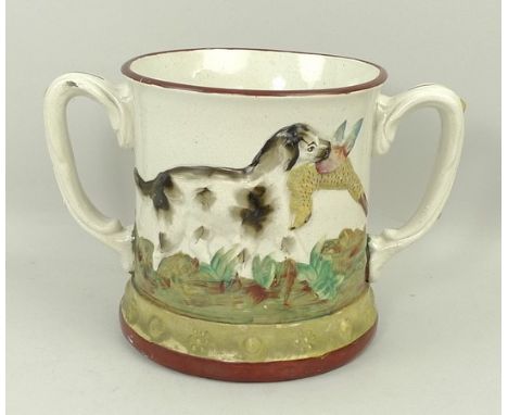 A Staffordshire pottery loving mug, mid 19th century, moulded internally with a frog, externally with hunting dogs and game b