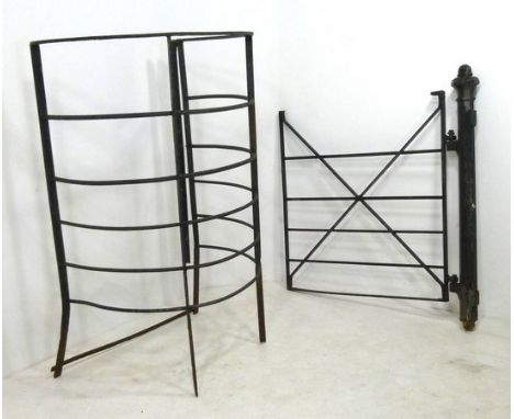 A wrought iron kissing gate, circa 1900, with cast iron post, the curved section, 122 by 142cm high, the gate and post, 70 by