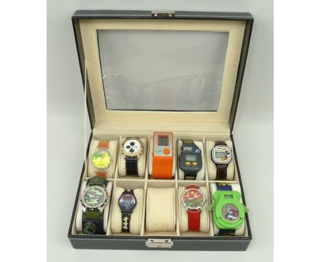 A quantity of LCD comic and novelty watches, comprising Teenage Ninja Mutant Turtles, Mickey Mouse, Chairman Mao, FM Autoscan