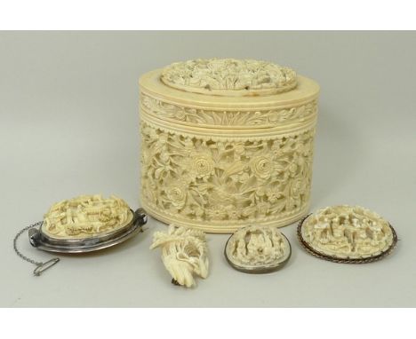 A Cantonese ivory trinket box and lid, late 19th century, of oval section carved in bas relief with flowers, 10 by 7.5cm high