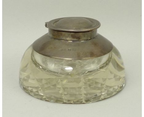 A cut glass inkwell with a silver mount and hinged lid, hobnail cut base, Birmingham 1909.