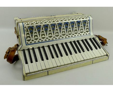 An Estella Italia accordion, mother of pearl finish, with 120 buttons, original case.