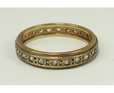 A gold and zircon set full eternity ring, size R, 2.9g. 