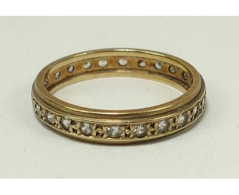 A gold and zircon set full eternity ring, size R, 2.9g. 