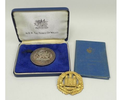 A 1969 HRH Prince of Wales Investiture silver medal, 3.58toz, in the original presentation case, a British Army The Northampt