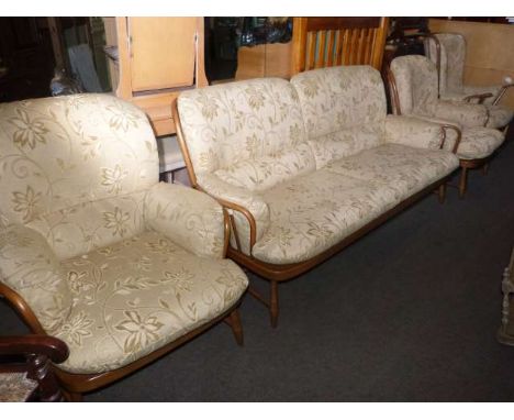 Four piece Ercol lounge suite in light gold floral pattern fabric comprising three seater settee and three armchairs together