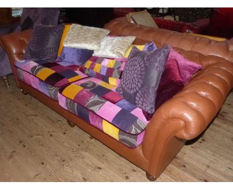 Brown leather deep button back Chesterfield settee, complete with multi coloured seat covers and cushions