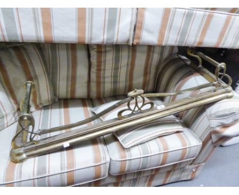 A BRASS ORNATE FIRE FENDER 