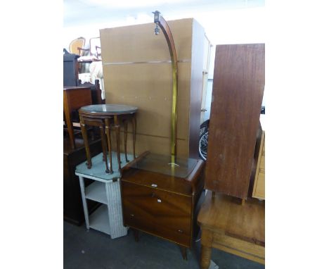 A SMALL ART DECO WALNUTWOOD LOW COCKTAIL CABINET WITH FALL-FRONT AND GLASS SHELF AND A STANDARD LAMP ABOVE