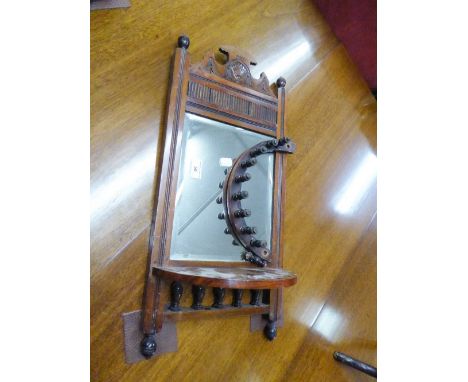 A CARVED WOOD FRAMED OBLONG BEVELLED EDGE SMALL WALL MIRROR, WITH DEMI-LUNE GALLERIED SHELF BELOW 