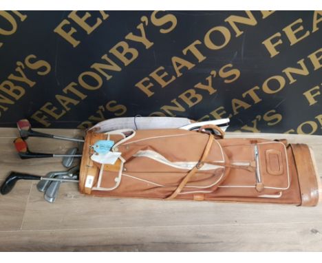 A VINTAGE GOLF BAG CONTAINING CLUBS SUCH AS RALLY TOURNAMENT AND WILSON