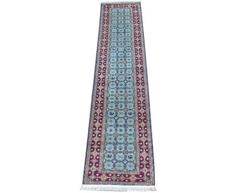 A Varamin runner, each of the light blue panels centred by a floral motif, 347 x 80cms