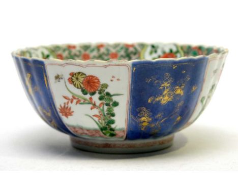 A Chinese famille verte powder-blue ground fluted bowl, Kangxi, decorated with a central urn of flowers, diaper and floral bo