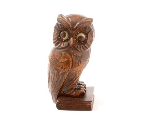 An early 20th Century German Black Forest owl pattern clock, with minute and hour pointing eyes, in carved oak case, the owl 