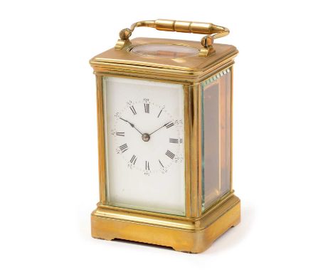 An early 20th Century carriage clock, the white enamel roman dial fitted movement with platform lever escapement, in plain br