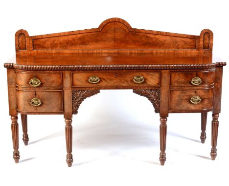 A William IV mahogany sideboard, with architectural back, shaped rectangular top with straight gadrooned edge above a central