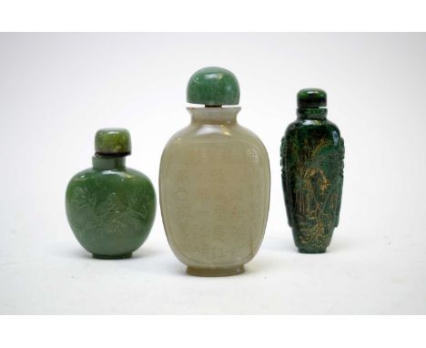 A Chinese pale green jade snuff bottle, engraved with inscription and diaper, green hardstone stopper, 8.5cms; a green hardst