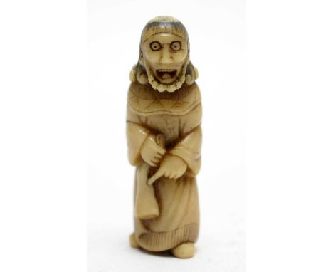 A Japanese carved horn Netsuke, 18th century, in the form of a Dutch merchant with scull cap and long hair and beard, depicte