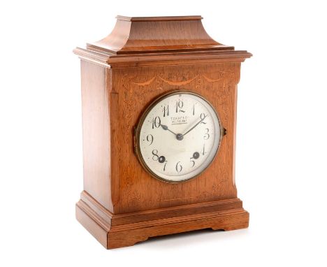 An early 20th Century inlaid walnut quarter striking mantle clock, retailed by T. Gaunt &amp; Co. Melbourne, the silvered ara