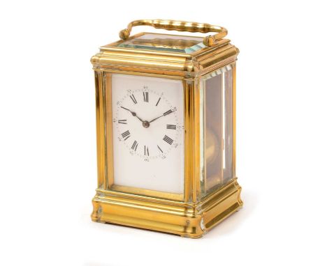 An early 20th Century French carriage clock, retailed by J.W. Benson, London, the white enamel roman dial fitted movement wit