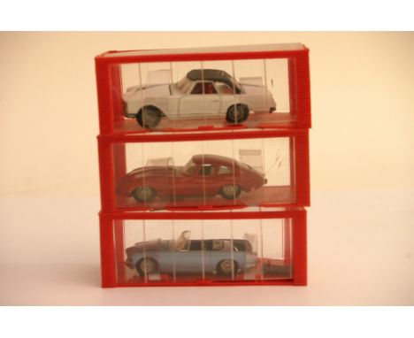 Three Dinky small scale models cars in boxes.