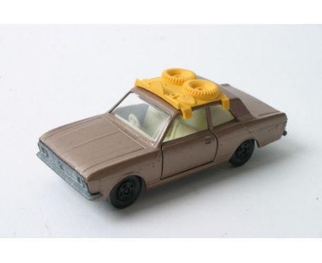 A Matchbox Superfast Ford Cortina No. 25 in metallic light brown having unusual roof load with black plastic wheels missing h