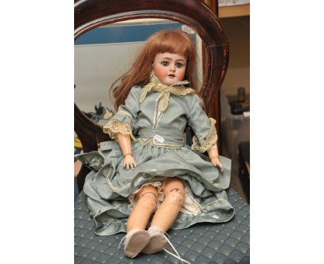 An early 20th German century bisque head and composition doll with double jointed body, the head stamped Heinrich Handwerck S