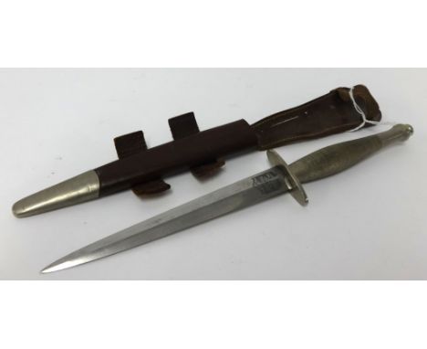 A Fairburn Sykes early second pattern commando fighting knife by Wilkinson with leather scabbard, the blade stamped The F-S F