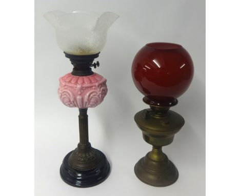 Victorian oil lamp with pink glass embossed reservoir and etched shade together with a brass oil lamp each with chimney (2)