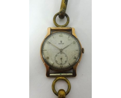 Rolex, a vintage gold cased wristwatch with manual wined movement, subsidiary second dial, running.