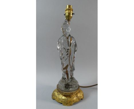 A Gilt Metal and Glass Figural Table Lamp in the Form of a Robed Elder. 38cms High 