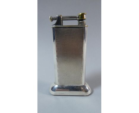 A Vintage Silver Plated Dunhill Lighter with Engine Turned Decoration. 10cms High 