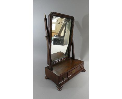A Georgian Mahogany Swing Toilet Mirror on Plinth Base with Centre Long Drawer Flanked by Two Small Drawers. Ogee Bracket Fee