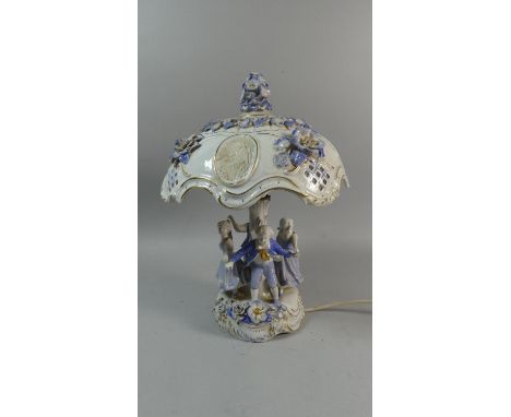 A Late 20th Century East German Porcelain Table Lamp in the Form of Children Playing Ring a Ring of Roses Around Tree, 38cms 