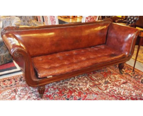 SOFA, William IV mahogany, with overscrolled arms and buttoned squab cushion in brown leather on reeded legs and brass castor