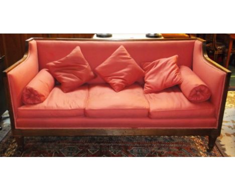 SOFA, Regency mahogany in pink fabric with seat, bolster and loose cushions on reeded legs and brass castors, 177cm W x 76cm 