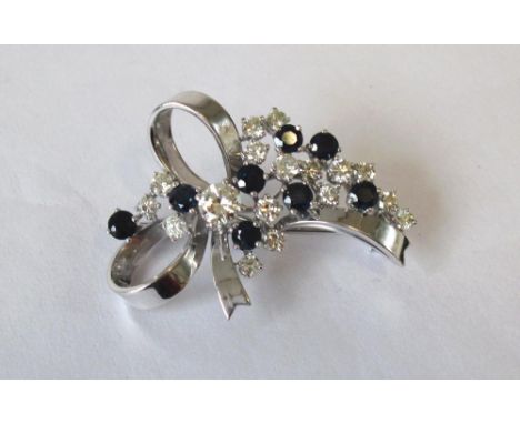 DIAMOND AND SAPPHIRE BROOCH, seventeen round brilliant cut diamonds amongst eight brilliant cut sapphires set on a 18K white 