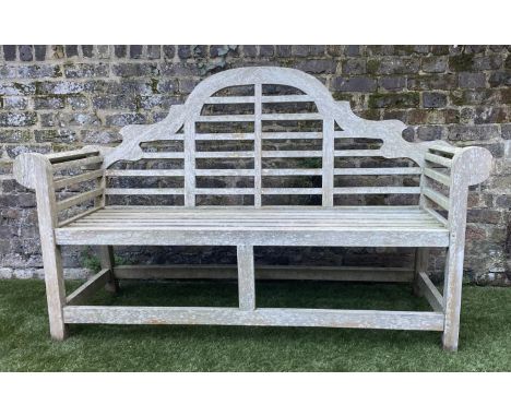 LUTYENS STYLE GARDEN BENCH, weathered teak of slatted constructions after a design by Sir Edwin Lutyens, 165cm W. 