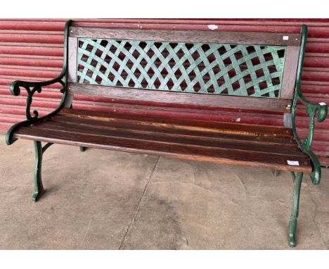 A cast iron and painted pine garden bench 