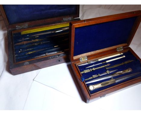 DRAWING SETS. Two boxed drawing sets including ivory handled examples