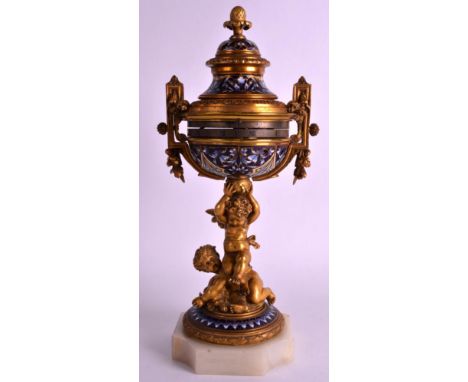 A FINE 19TH CENTURY FRENCH ORMOLU AND CHAMPLEVE ENAMEL MANTEL CLOCK with revolving dial, supported with two young bacchanalia
