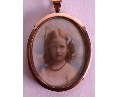 A VICTORIAN PINCHBECK PENDANT hand painted with a portrait of a young girl by Priestley. 