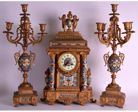 A LATE 19TH CENTURY FRENCH GILT METAL AND CHAMPLEVE ENAMEL CLOCK GARNITURE decorated with flowers, the mantel surmounted with
