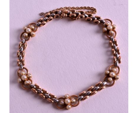 AN EDWARDIAN LADIES 9CT ROSE GOLD AND SILVER BRACELET with floral seed pearl surround. 12.5grams.