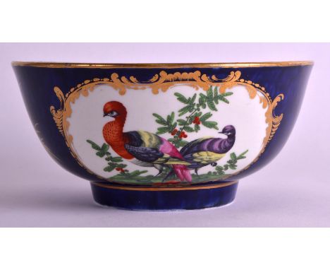 A FINE 18TH CENTURY WORCESTER BLUE SCALE PORCELAIN BOWL painted with two panels of exotic birds within landscapes. 6.5ins dia